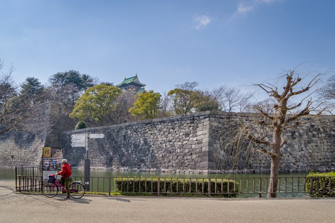 Cyclist at Osaka Castle - Osaka, Japan